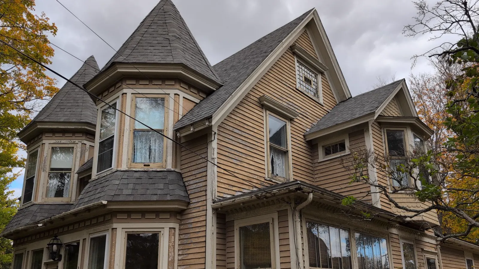 Aged Victorian roof under a heavy storm sky in Sackville, photographed during a Plus Ultra roof inspection
