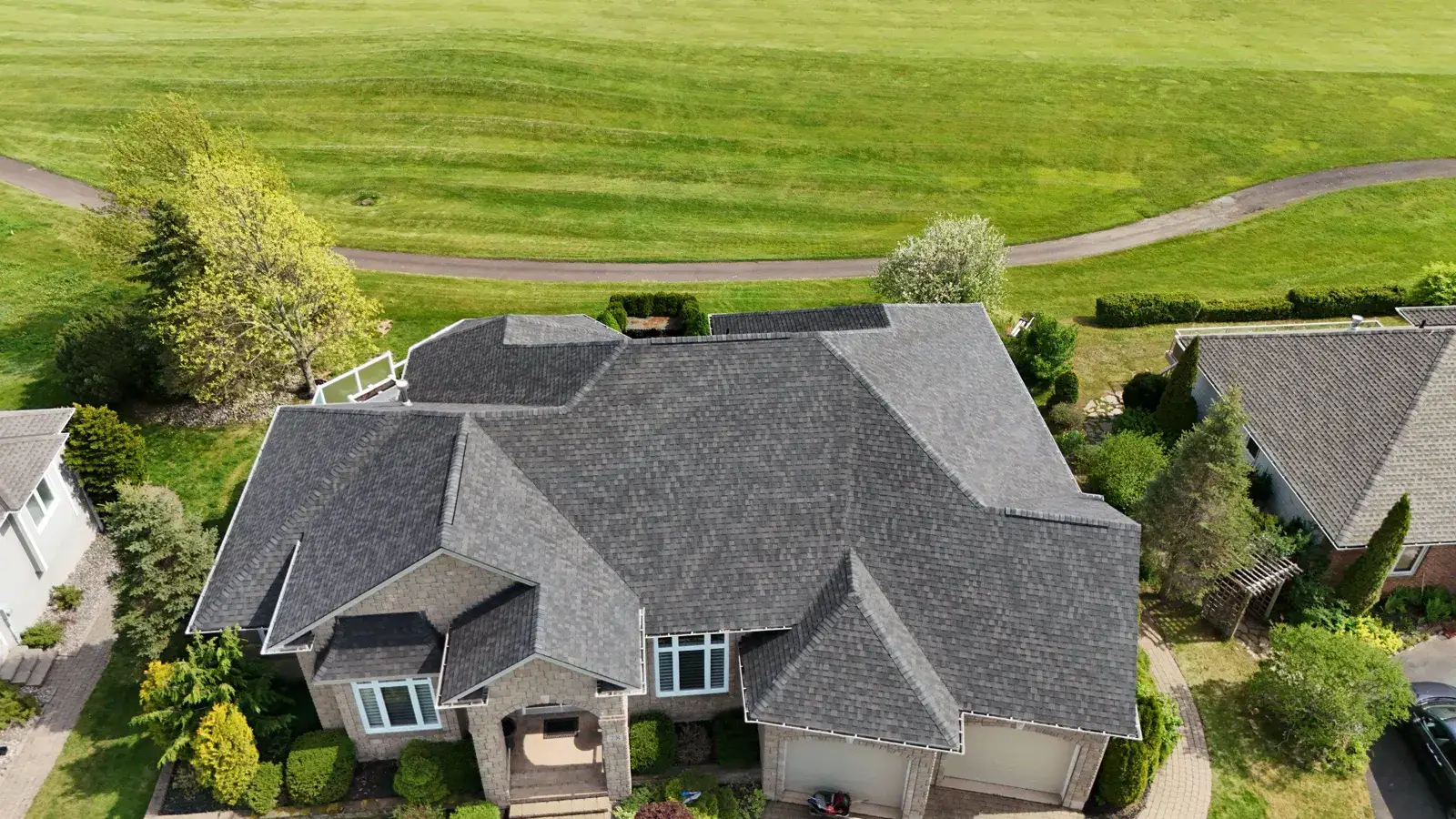 Finished roof replacement on a golf-course estate home in Moncton, photographed from our drone