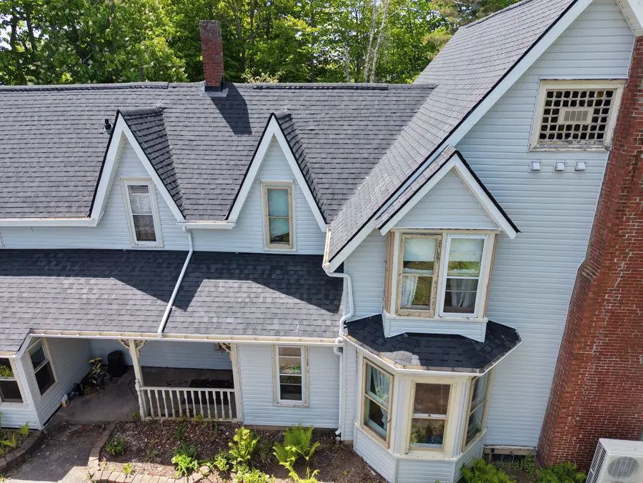this Sackville Victorian front elevation after: restored Victorian with black roof and black turret gables