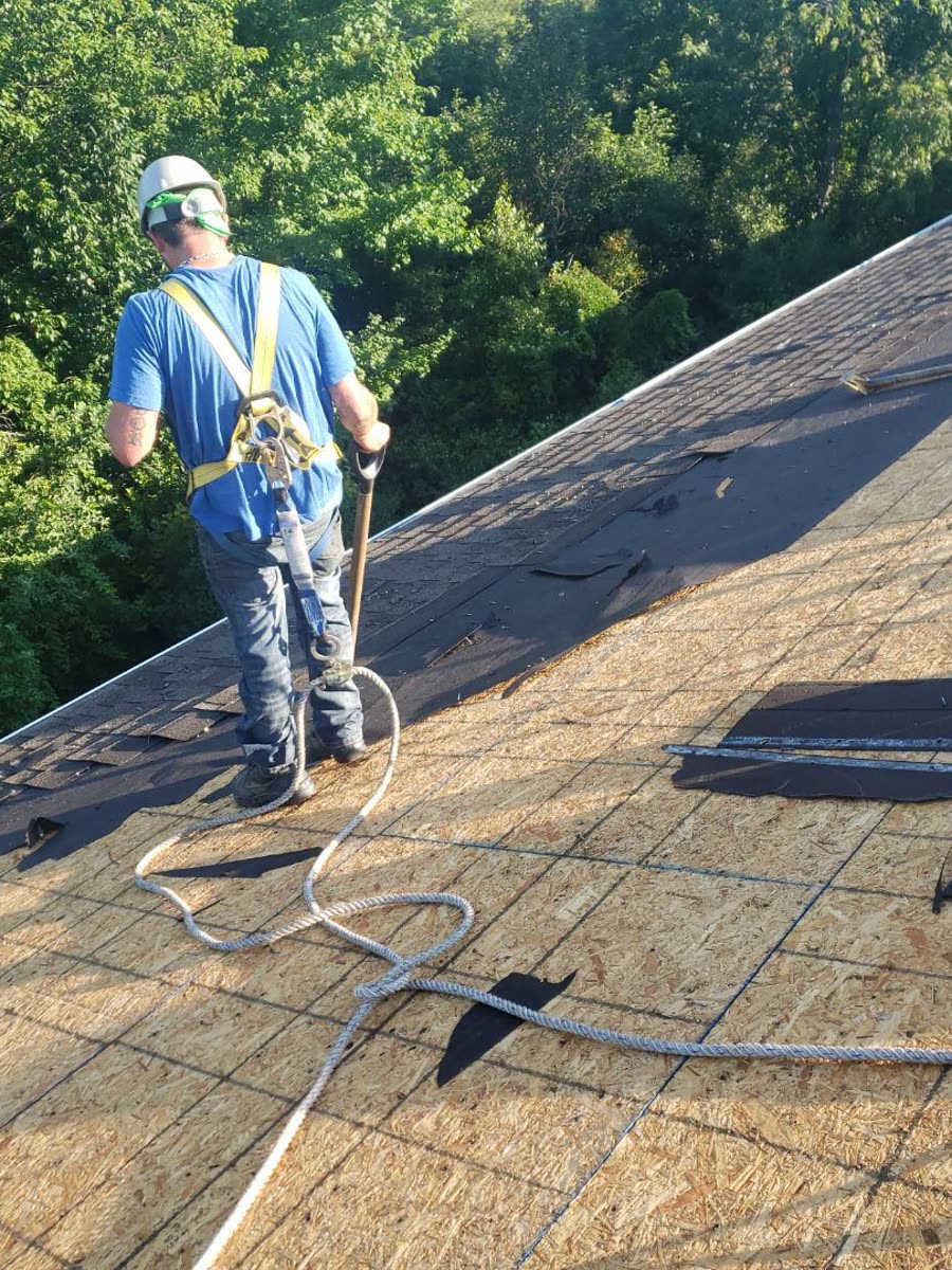 Plus Ultra roofer harnessed and tied off to a lifeline on open decking