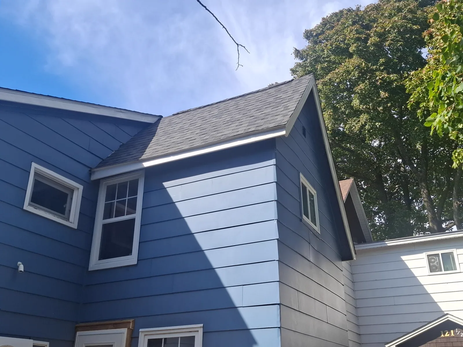 Finished dark architectural shingle roof on this Moncton home