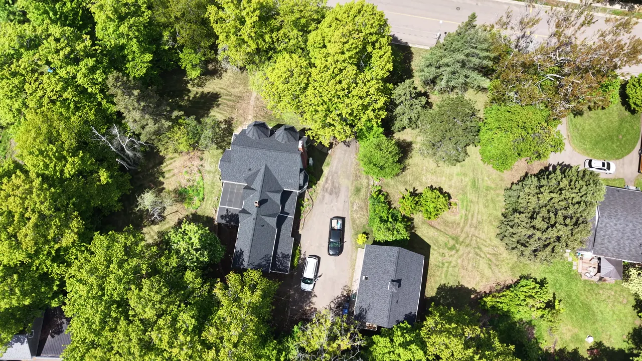 The finished this Sackville Victorian property from the air: new black roof, new siding, carriage house and grounds
