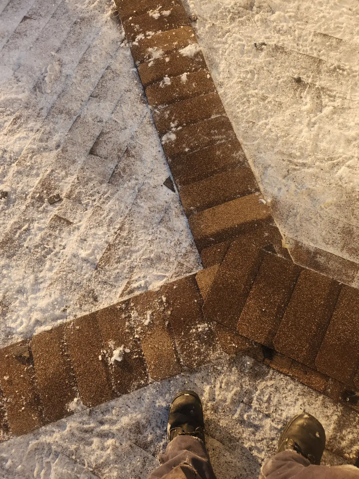 New shingle courses going down on a winter install in New Brunswick, photographed from the roof